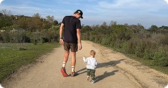 Dad and toddler walking together